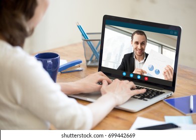 Businesswoman talking on video conference to businessman showing document at webcam, colleagues discussing work by video call application, financial consultant consulting client online, close up view - Shutterstock ID 699442669