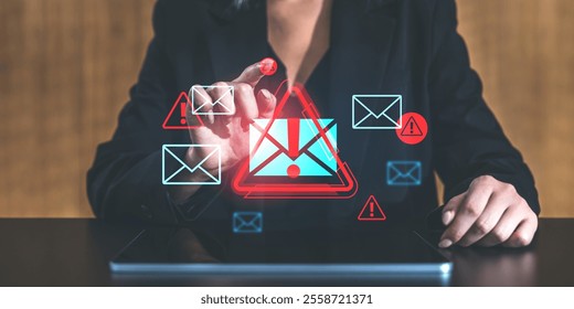 Businesswoman tapping virtual warning icons of email alerts on a tablet screen, showcasing technology and spam concepts