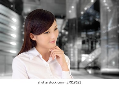 Businesswoman thinking inside of modern architecture, closeup portrait of oriental office lady. - Shutterstock ID 57319621