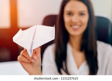 Businesswoman Tossing Paper Airplane