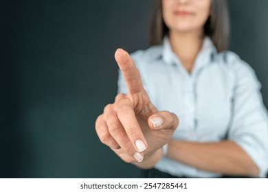 Businesswoman touching concepts in studio. Business woman pushing on a touch screen interface - Powered by Shutterstock