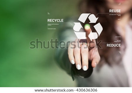 Businesswoman touching recycling symbol on  touch screen. Environmental concept recycle - reduce - reuse.