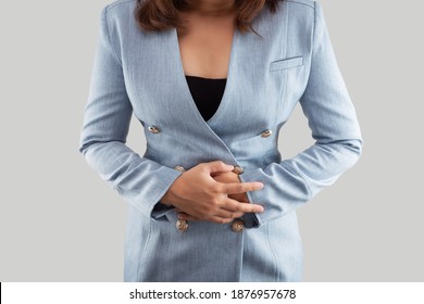 Businesswoman Touching Stomach Painful Suffering From Period Cramps. The Photo Of Large Intestine Is On The Woman's Body. Irritable Bowel Syndrome