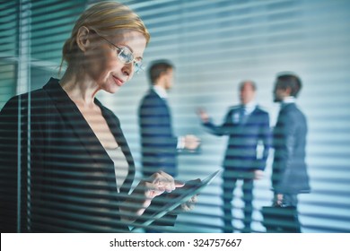 Businesswoman with touchpad working in office
