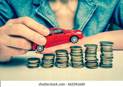 Businesswoman and toy car on coin stack - insurance, loan and buying car concept - retro style - Powered by Shutterstock