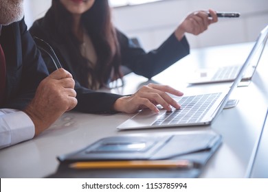 Businesswoman  Typing On Laptop. Beautiful Young Asia Woman Sitting Together With Her Old White Man Boss Discuss Business Plan. Cross Generation Business Team Concept.