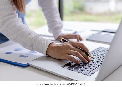 A businesswoman typing on a laptop, she is talking to an employee using a laptop messenger to inquire about company finances. The concept of using technology to assist in communication.