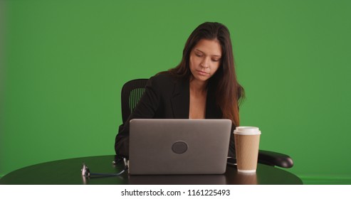 Businesswoman Typing On Laptop Sitting At Cafe On Green Screen