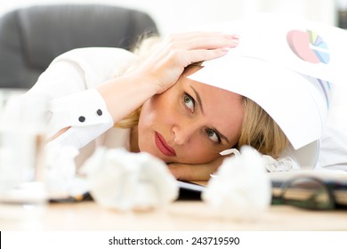 Businesswoman under pile of documents surrounded crumpled papers