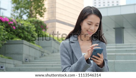 Businesswoman use of smart phone in city