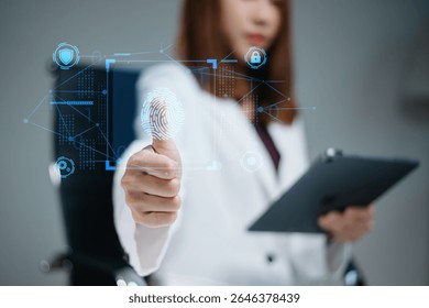 Businesswoman using biometric fingerprint ID on digital screen. Cybersecurity, privacy protection, data access, and tech innovation. Real people in secure tech scene.