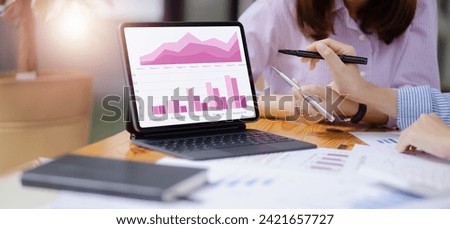 Businesswoman using digital tablet with business infographic data concept.