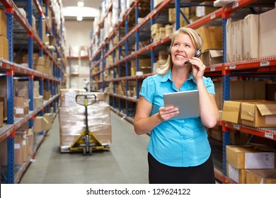 Businesswoman Using Digital Tablet In Distribution Warehouse