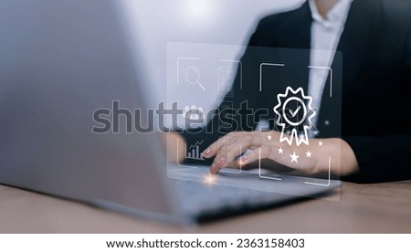 Businesswoman using laptop computer with quality assurance and document icon for ISO or International Standard Organisation which related quality control and continuous improvement concept.