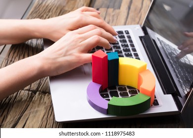 Businesswoman Using Laptop With Multi Colored 3d Pie Chart - Powered by Shutterstock