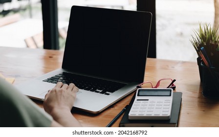 Businesswoman Using Mockup Laptop While Working With Calculator For Financial. 
