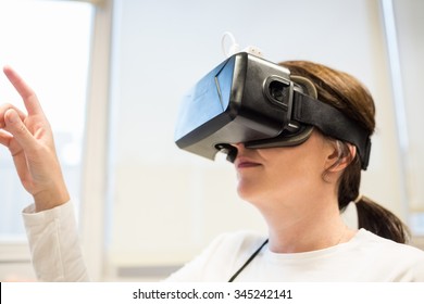 Businesswoman using oculus rift headset in the office