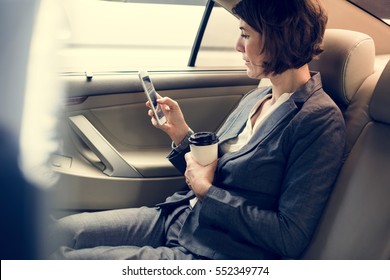 Businesswoman Using Smart Phone Car Inside