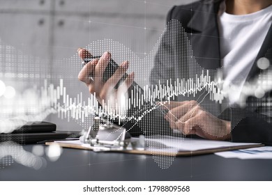 Businesswoman using smart phone in office. Forex chart hologram. On-line trading stock market concept. Double exposure.