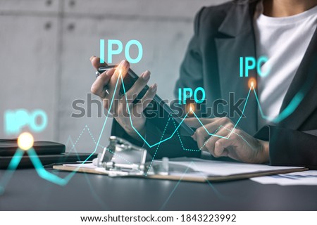 Businesswoman using smart phone in office. IPO hologram. Stock public offering concept. Double exposure.