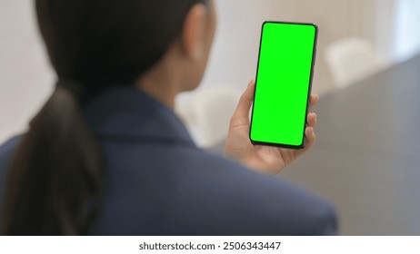 Businesswoman Using Smartphone with Green Screen - Powered by Shutterstock