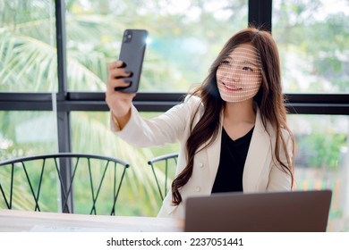 Businesswoman using smartphone to scan face for identity verification to unlock in digital connection access to financial transaction data, facial recognition technology, data protection. - Shutterstock ID 2237051441