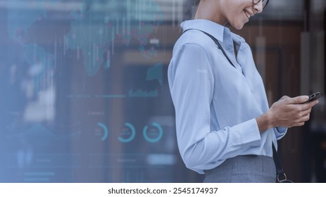 Businesswoman using smartphone, smiling, with digital graphs overlay. Professional attire, technology, and modern data visualization. Smartphone, technology, connection concept with copy space. - Powered by Shutterstock