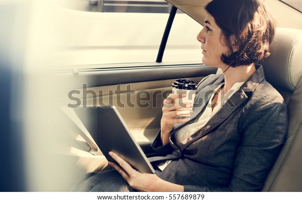 Businesswoman Using Tablet Car\
Inside