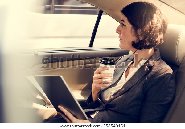 Businesswoman Using Tablet Car
Inside