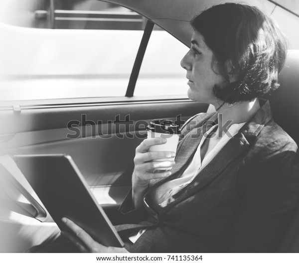 Businesswoman Using Tablet Car\
Inside