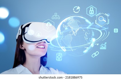 Businesswoman in vr headset smiling, looking at digital earth hologram with icons hud. Metaverse and global connection. Concept of global internet and digital marketing