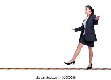 Businesswoman walking along a tightrope, isolated on a white background.