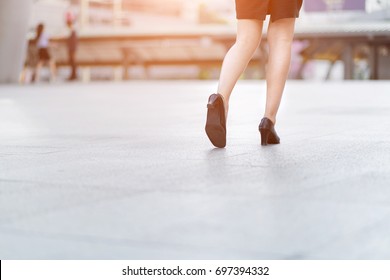 Businesswoman Walking Away Low Angle Cross Section In City.