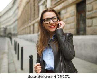 Businesswoman Walking Down The Street While Talking On Smart Phone. Happy Smiling Caucasian Business Woman Busy