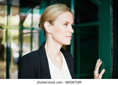 Businesswoman Walking Through Doorway