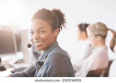 Businesswoman wearing headset in office - Powered by Shutterstock