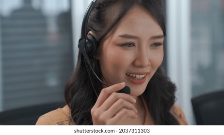 Businesswoman Wearing Headset Working Actively In Office . Call Center, Telemarketing, Customer Support Agent Provide Service On Telephone Video Conference Call.