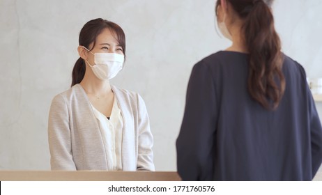 Businesswoman Wearing Mask Talking To Customer