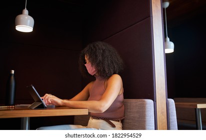 Businesswoman Wearing Mask Working In Socially Distanced Cubicle In Office During Health Pandemic