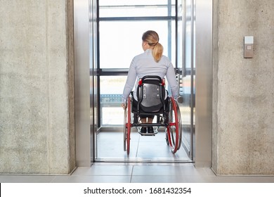 Businesswoman In A Wheelchair Drives With The Elevator In The Business Company