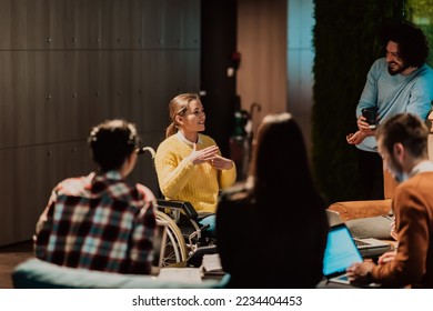 Businesswoman in wheelchair having business meeting with team at modern office. A group of young freelancers agree on new online business projects - Powered by Shutterstock