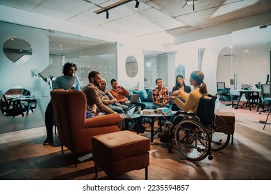 Businesswoman in wheelchair having business meeting with team at modern office. A group of young freelancers agree on new online business projects - Powered by Shutterstock