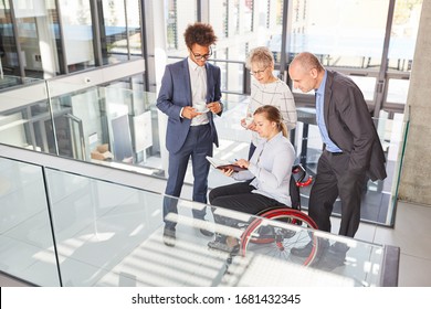 Businesswoman in wheelchair makes appointment planning with colleague during coffee break