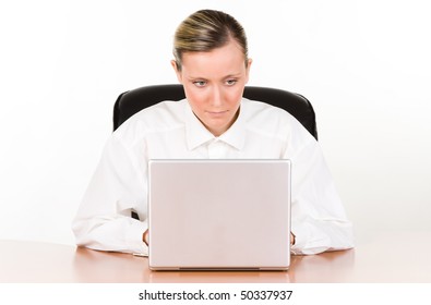 Businesswoman in white dress shirt with a laptop at a desk.