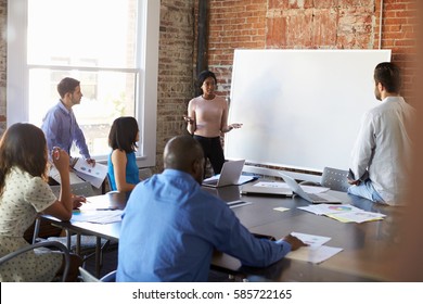 Businesswoman At Whiteboard In Brainstorming Meeting