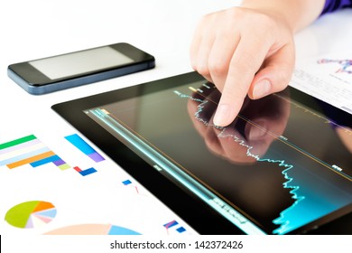 Businesswoman work with documents and tablet computer