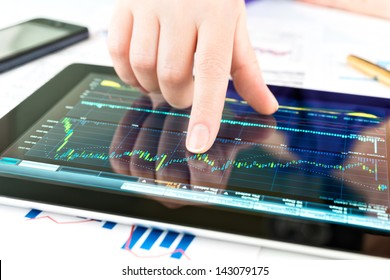 Businesswoman work with documents and tablet computer - Powered by Shutterstock