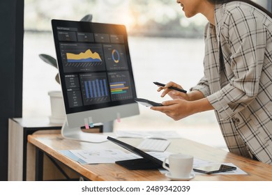 Businesswoman working and calculating on digital financial dashboard, planning business growth, strategy digital marketing, profit income, economy