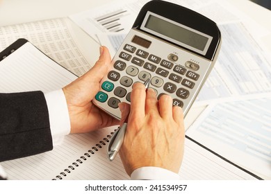 Businesswoman working with calculator in the office