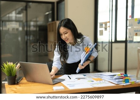 Businesswoman working with computer and office supplies.